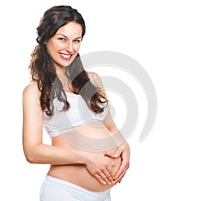 Happy pregnant woman touching her belly