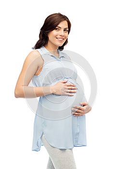 Happy pregnant woman touching her big belly