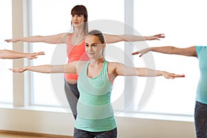 Happy pregnant women exercising in gym