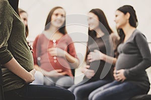 Happy pregnant women are talking together at antenatal class at the hospital