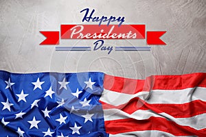 Happy President`s Day - federal holiday. American flag and text on grey stone background, top view