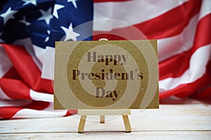 Happy President`s Day text message with USA flag on wooden background