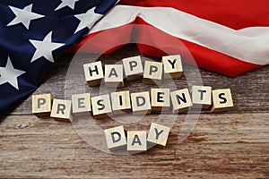 Happy Presidents Day Word alphabet letters with USA flag on wooden background