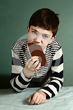 Happy preteen boy with chocolate bar