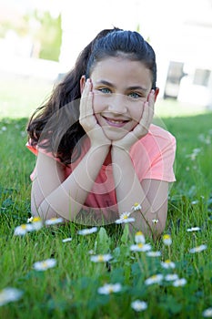 Happy preteen girl lying in the grass