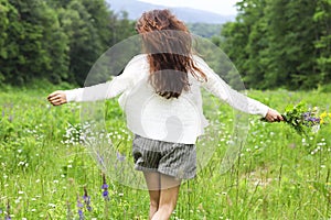 Happy pretty brunette woman in chamomile field photo