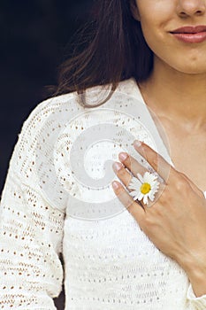 Happy pretty brunette woman in chamomile field photo