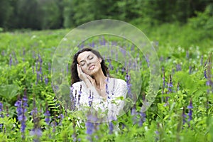 Happy pretty brunette woman in flower field
