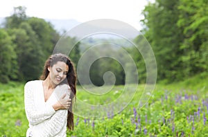 Happy pretty brunette woman in flower field