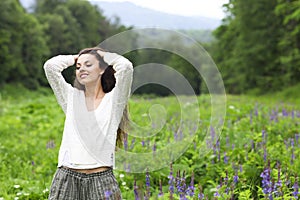 Happy pretty brunette woman in flower field photo