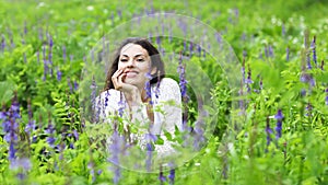 Happy pretty brunette woman in flower field photo