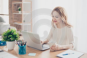 Happy pretty cute woman working with computer drinking coffee
