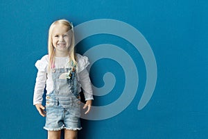 Happy pretty girl on blue wall background