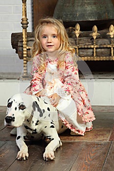 Happy pretty little girl in medieval costume sits