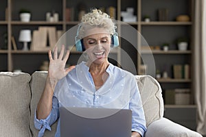 Happy pretty mature freelancer business woman making video call