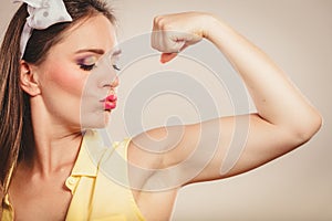 Happy pretty pin up girl showing off muscles.