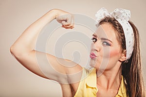 Happy pretty pin up girl showing off muscles.
