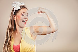 Happy pretty pin up girl showing off muscles.