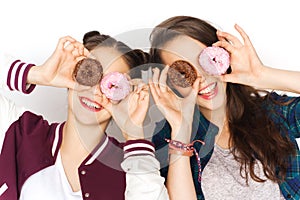 Happy pretty teenage girls with donuts having fun