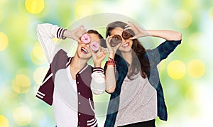 Happy pretty teenage girls with donuts having fun