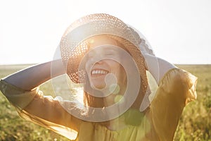 Happy pretty woman with hat smiling and enjoying summer