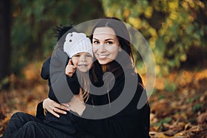 Happy pretty woman with her kid resting outdoors