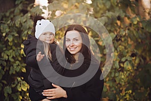 Happy pretty woman with her kid resting outdoors