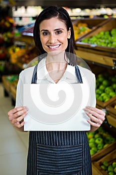 Happy pretty woman holding white sign