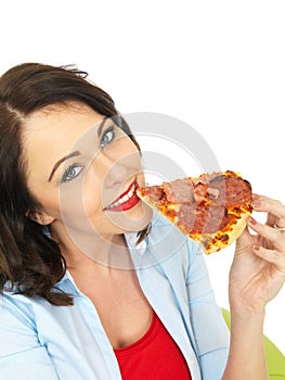 Happy Pretty Young Woman Eating a Slice of Freshly Baked Pepperoni and Ham Pizza