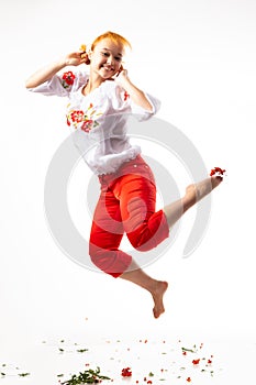 Happy pretty young woman holding gift box over gray background