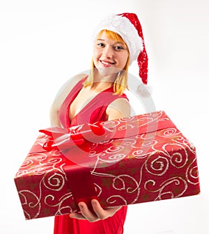 Happy pretty young woman holding gift box over gray background