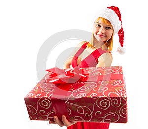 Happy pretty young woman holding gift box over gray background