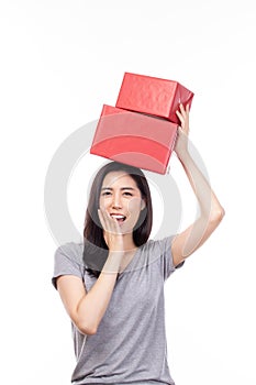 Happy pretty young woman holding gift box present in christmas or new year on white background