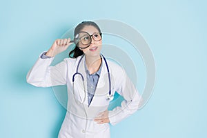 Happy professional doctor woman holding magnifier