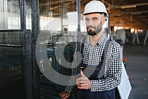 Happy Professional Heavy Industry Engineer Worker Wearing Uniform, and Hard Hat in a Steel Factory. Smiling Industrial