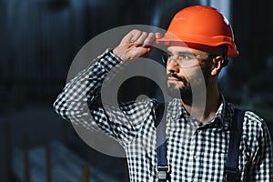 Happy Professional Heavy Industry Engineer Worker Wearing Uniform, and Hard Hat in a Steel Factory. Smiling Industrial