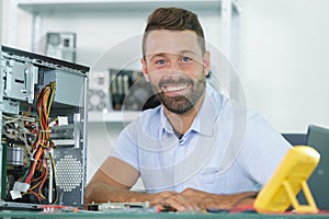 happy professional man repairing and assembling computer