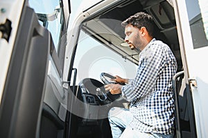 Happy professional truck driver driving his truck. Copy space.