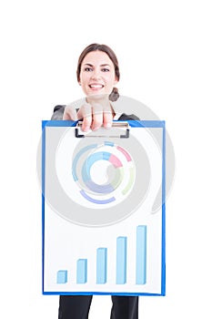 Happy and proud sales woman holding clipboard with financial cha