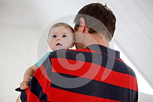 Happy proud young father having fun with newborn baby daughter, family portrait togehter. Dad with baby girl, love