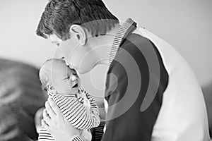 Happy proud young father having fun with newborn baby daughter, family portrait togehter. Dad with baby girl, love. New