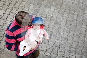 Happy proud young father with newborn baby daughter, family portrait togehter