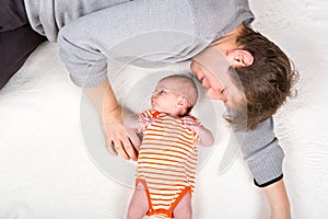 Happy proud young father with newborn baby daughter, family portrait togehter