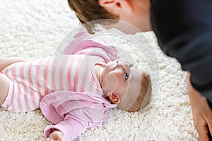 Happy proud young father with newborn baby daughter, family portrait together