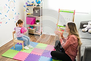 Happy psychologist having a therapy session with a child