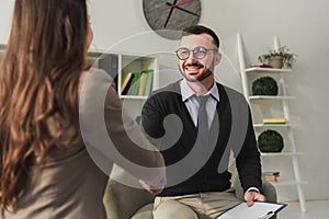 happy psychologist and patient shaking hands