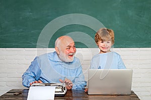 Happy Pupil with over blackboard background. Elementary school teacher and student in classroom. Father teaching her son