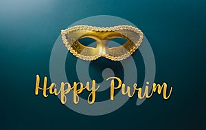 Happy Purim carnival decoration concept made from golden mask on dark background.