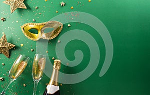 Happy Purim carnival decoration concept made from golden mask, wine, and sparkle star on green background. Happy Purim in Hebrew