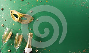 Happy Purim carnival decoration concept made from golden mask, wine, and sparkle star on green background. Happy Purim in Hebrew